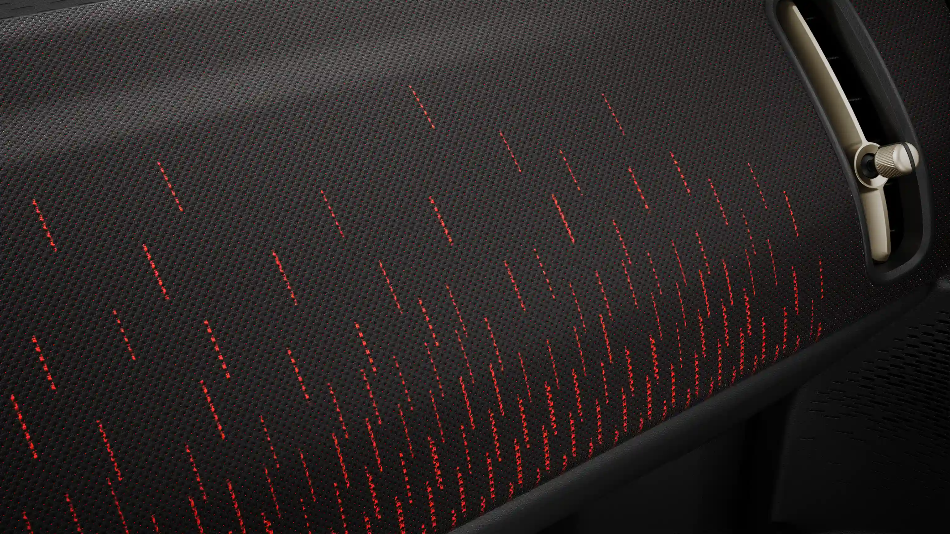 Ansicht des Armaturenbretts im vollelektrischen MINI Countryman John Cooper Works Trim in Rot und Schwarz